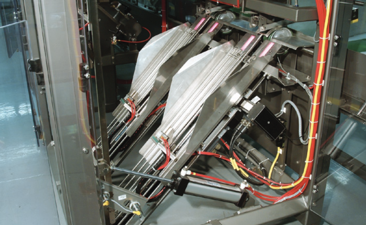 Two ganged Tolomatic actuators center the bags in the staging trays while two other actuators adjust the vertical position